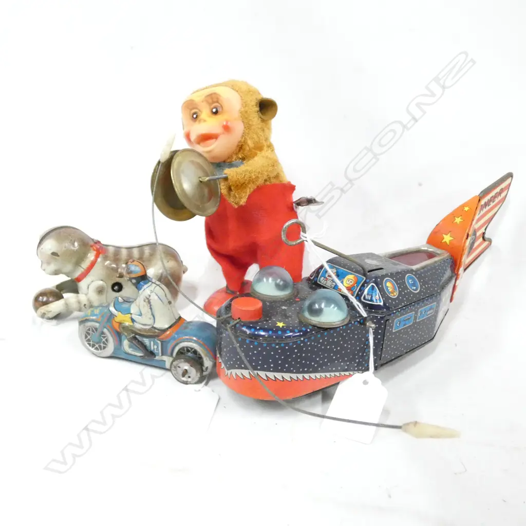 2 TIN PLATE WIND UP TOYS; ROCKET SHIP -. BUG EYES & CAT WITH BALL  & PLASTIC WIND UP MONKEY WITH SYMBOLS Image 1++